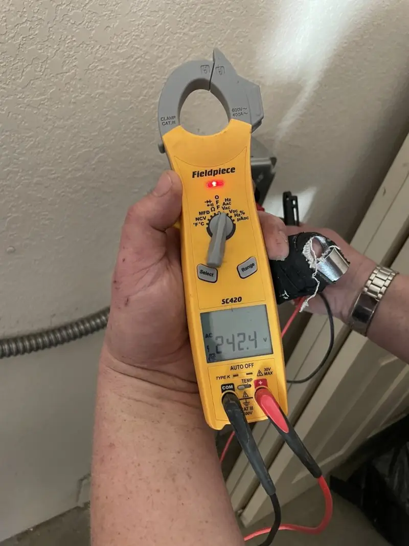Voltage testing with clamp meter during Recessed Lighting Installation in Wilmer